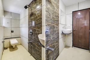 a bathroom with a sink and a toilet and a shower at OYO Hotel Signature in Ahmedabad