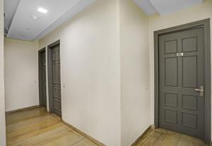 an empty hallway with two doors and wood floors at Townhouse in New Delhi
