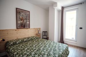 a bedroom with a bed and a picture on the wall at Art Village Residence in Bisceglie +147 photos
