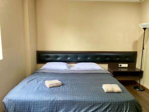 a bedroom with a bed with two towels on it at Syaz Meridien Hotel in Melaka