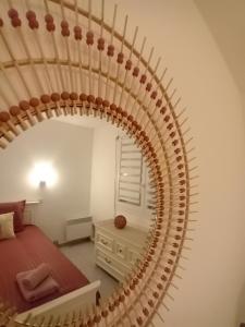 a circular mirror in a bedroom with a bed at Bas de villa proche plages et calanques in Marseille
