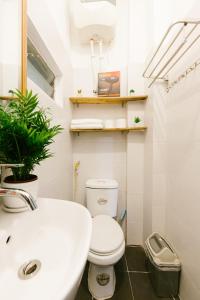 a bathroom with a white toilet and a sink at Hi.Home Old Quarter Big Group 1min Ta Hien in Hanoi