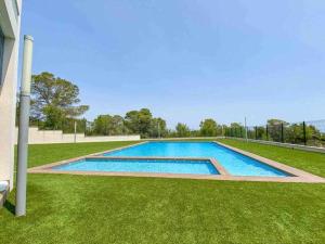 - une piscine au milieu d'une pelouse dans l'établissement Top floor Pink Vistagolf - Winter by the sea, à San Miguel de Salinas