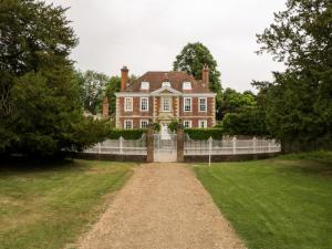 a large house with a fence in front of it at 36 High Street in Salisbury