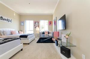 a living room with a bed and a couch and a tv at Loft apartments at Hollywood FREE parking close to Studios Universal in Los Angeles