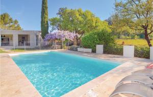 a swimming pool in the backyard of a house at Lovely Home In Aubais With Wifi in Aubais +26 photos
