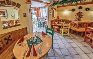 a restaurant with tables and chairs in a room at Nice Home In St Georgen Am Kreischb, With Sauna, Wifi And Indoor Swimming Pool in Sankt Lorenzen ob Murau