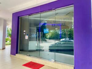 a purple doorway to a store with a car in the window at Syaz Meridien Hotel in Melaka