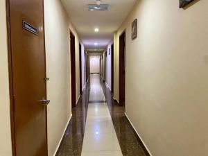 an empty hallway with doors and a long corridor at Syaz Meridien Hotel in Melaka +18 photos