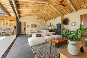 a living room with a couch and a table at Wabi Sabi Tropical Seaview Villa in Mae Nam