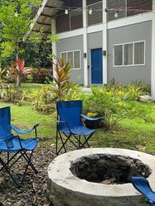 two chairs and a fire pit in a yard at CamiStays Homestay in Camiguin, Best for Groups or Family in Mambajao