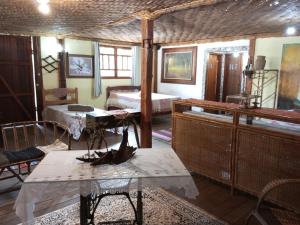 a room with a bed and a table in a room at Fazenda Mundo Novo in Divisa