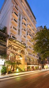 a large white building on the side of a street at Thien Thai Hotel & Spa in Hanoi