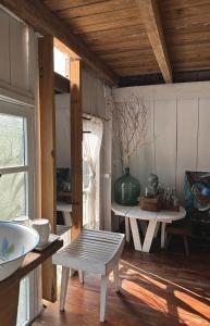 a room with a bench and a table and a window at Dreamer Cabin Tre house Dalat in Da Thien +30 photos