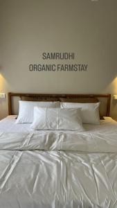 A bed or beds in a room at SAMRUDHI ORGANIC FARMSTAY