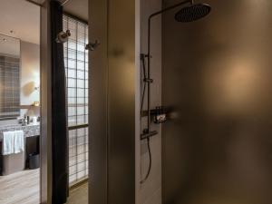 a bathroom with a shower and a door at NOA Hotel & SPA Shenzhen in Shenzhen