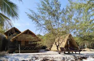 a resort with thatched huts in the woods at GreenBlue Beach Bungalows in Koh Rong Sanloem
