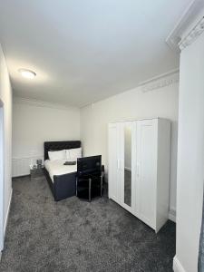 a bedroom with a bed and a tv in it at Luxury Ensuite Rooms @ Kingsley Terrace in Newcastle upon Tyne