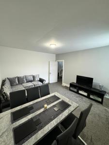 a living room with a couch and a table at Luxury Ensuite Rooms @ Kingsley Terrace in Newcastle upon Tyne