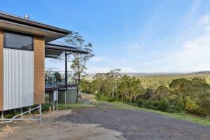 a house in the bush with a view at Affinity Luxury Studio with Spa and Amazing Views in Ravensbourne