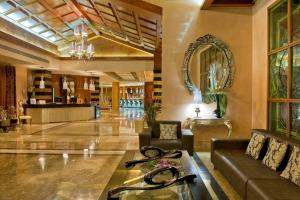 a lobby of a hotel with a couch and a table at Elba Costa Ballena Beach & Thalasso Resort in Costa Ballena