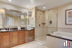a bathroom with a tub and a sink and a shower at MGM Signature-33-711 F1 Track & Strip View Balcony in Las Vegas
