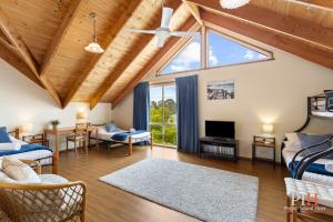a living room with a vaulted ceiling and a large window at Charming 3-Bedroom Retreat in Cowes