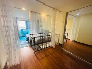 a room with a bed and a window with curtains at Laguna Beach resort 2-projector loft room in Jomtien Beach +40 photos