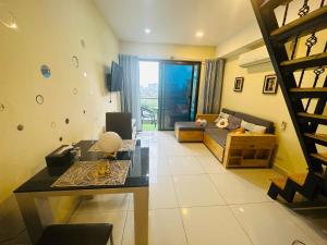 a living room with a couch and a table at Laguna Beach resort 2-projector loft room in Jomtien Beach