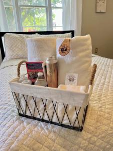 a basket on a bed with towels and other items at Little Hollywood Suite @ The Historic Kanab Inn in Kanab