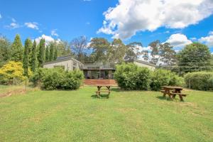 a house with a picnic table in the grass at The Base Two in Harrietville