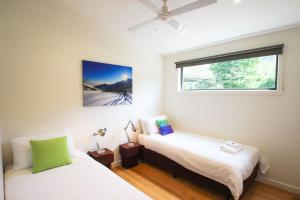 a bedroom with two beds and a window at The Base Two in Harrietville