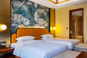Postel nebo postele na pokoji v ubytování Fondney Hotel Shanghai NECC Hongqiao Airport T2
