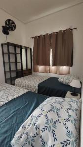 1 dormitorio con 2 camas y ventana en N03 Apartamento para até 4 hóspedes em Jacutinga, en Jacutinga