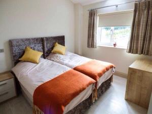 a bedroom with a large bed with a window at Shreyas Cottage in Blackburn