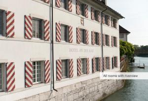 a building with red and white stripes on the windows at Hotel an der Aare Swiss Quality in Solothurn