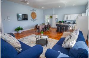 a living room with a blue couch and a kitchen at Stunning 3BR2BA Haven in Downtowns Heart in San Antonio