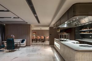 a kitchen and dining room with a table and chairs at Imperial Lexis Kuala Lumpur in Kuala Lumpur