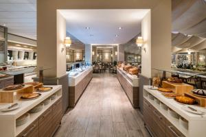 a bakery with many different types of food on display at Crowne Plaza Rome St. Peter's by IHG in Rome