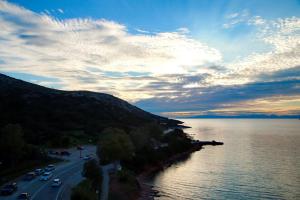 a view of a road next to a body of water at Suites Rania in Áyios Yeóryios