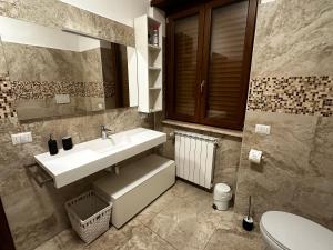 a bathroom with a sink and a toilet at A casa di Laura, bilocale moderno in La Massimina-Casal Lumbroso