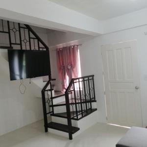 a room with a loft bed and a window at Ones stop shop Transient House in Butuan