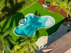 an overhead view of a swimming pool in the grass at 5000 Square Ft Beautiful Mansion w 6br Hot Tub Playground Movie Theater & Game Room in Dania Beach
