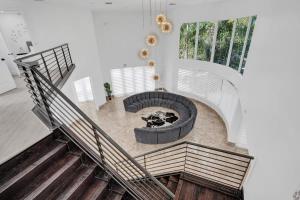 an overhead view of a living room with a fire pit at 5000 Square Ft Beautiful Mansion w 6br Hot Tub Playground Movie Theater & Game Room in Dania Beach