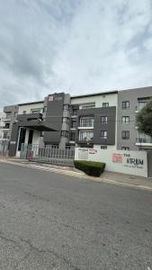 an apartment building on the side of a street at D&DLuxury Rivonia Apartments with inverter in Johannesburg