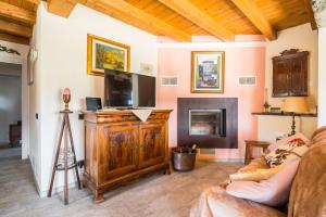 a living room with a couch and a flat screen tv at Fanano - Panoramic Villa by Alterego in Fanano