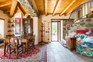 a dining room with a table and a stone wall at Fanano - Panoramic Villa by Alterego in Fanano