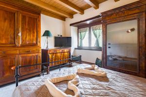 a bedroom with a large bed and a dresser at Fanano - Panoramic Villa by Alterego in Fanano