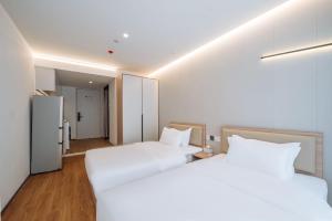 Katil atau katil-katil dalam bilik di 上海客堂涧酒店宝山路地铁站店