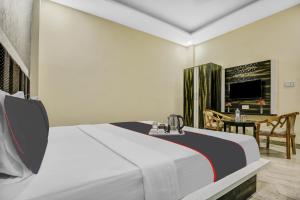 a hotel room with a bed and a dining room at OYO Hotel The Bliss in Chandīgarh